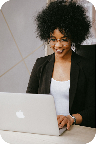 Professional woman smiling at laptop